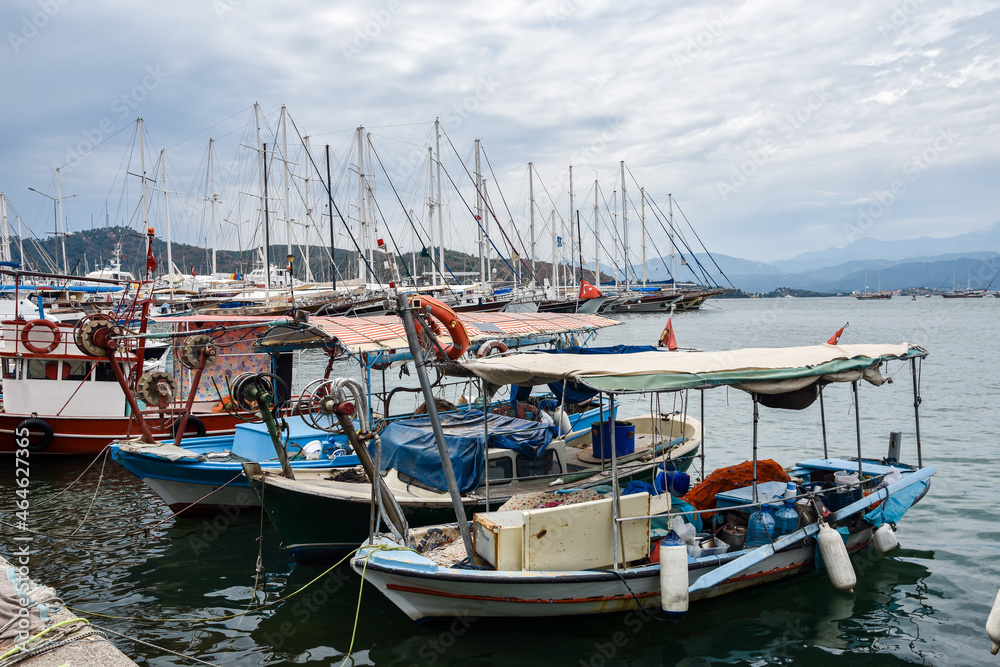 Yachts and boats in the harbor, Fethie, Turkey. The promenade of the city of Fethiye, boats are at bay in the blue waters of the Mediterranean. The resort town of Turkey.
