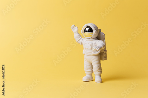 Canvas-taulu Plastic toy figure astronaut on a yellow background