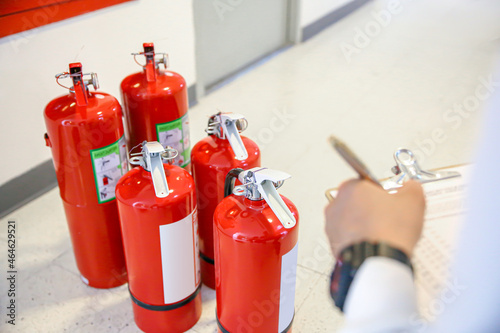 Wallpaper Mural Fire extinguisher, Engineer inspection checking pressure gauge level fire extinguisher tank with fire hose cabinet of protection and prevent emergency and safety rescue and fire alarm system training. Torontodigital.ca
