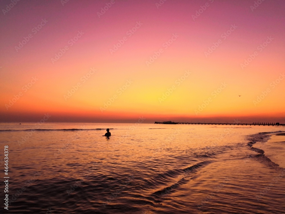 
very bright color of the sunset sky on the sea beach, turquoise, fiery red