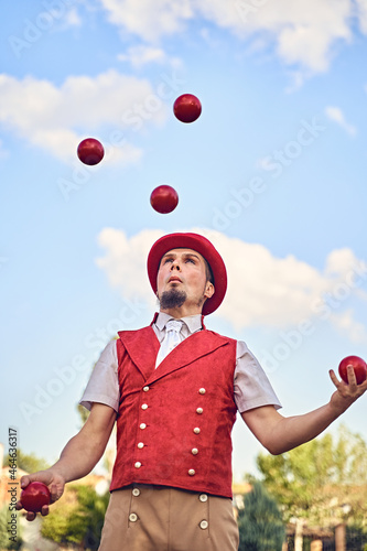 Man juggling balls in park