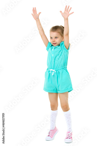 Little girl standing on tiptoes with her hands up