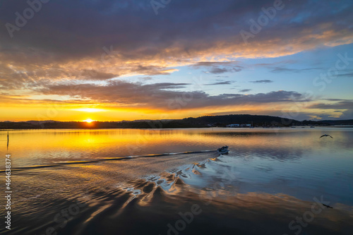 Sunrise aerial waterscape over the bay with cloud cover