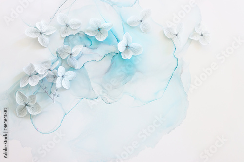 Creative image of pastel blue Hydrangea flowers on artistic ink background. Top view with copy space