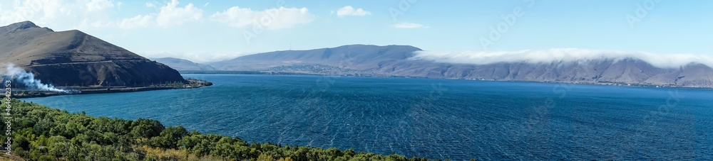 Armenia, Lake Sevan, September 2021. Panoramic view of the lake on a sunny autumn day. Armenia, Lake Sevan, September 2021. Panoramic view of the lake on a sunny autumn day.