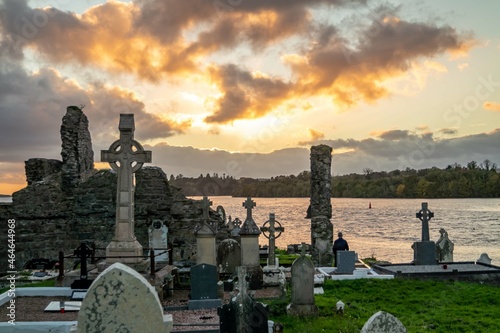 The sun is setting above the Abbey Graveyard which was build by Hugh O Donnell in 1474 - all names and artwork removed photo
