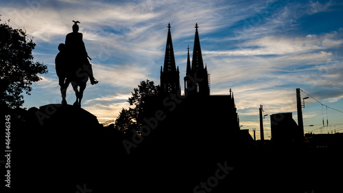 Black silhouette of Cologne Cathedral and Kaiser Wilhelm II equestrian statue. . photo