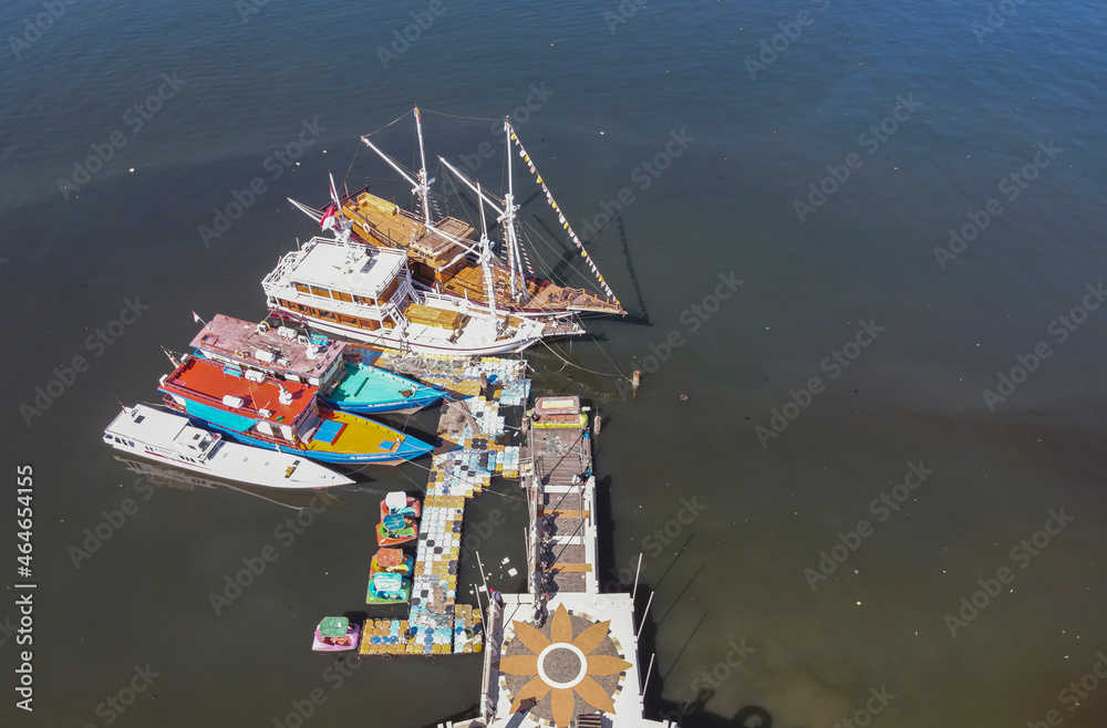 Phinisi traditional boats anchored at Losari Beach, Makassar, seen from a height. The Phinisi boat is a traditional wooden boat which is the hallmark and icon of the people of South Sulawesi, Indonesi