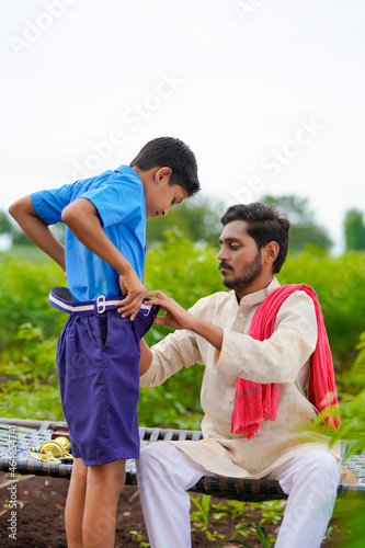 Indian farmer ready to his boy for going school