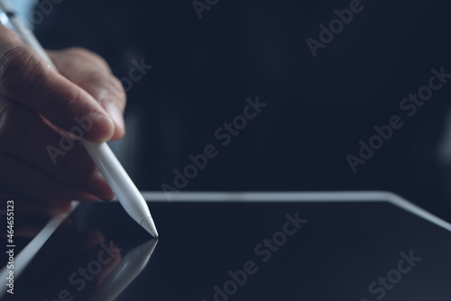 Close up of business man using stylus pen signing on digital tablet screen, e-signing, electronic signature concept