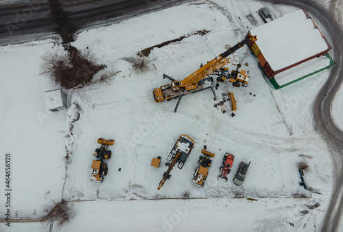 Mobile construction crane with yellow telescopic boom. installation of the bootloader. flying drone photo