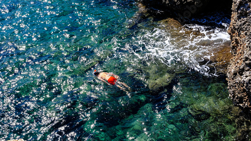 swimmer with mask swims in the turquoise sea of Menorca, Spain © karzof pleine