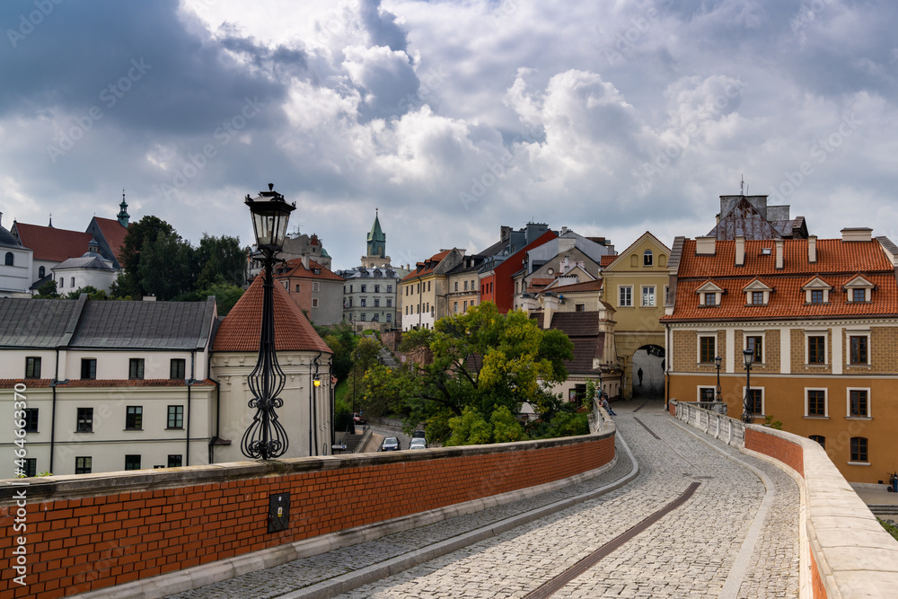 cobblestone street and bridge leading to the city gate and old town center of historic Lublin