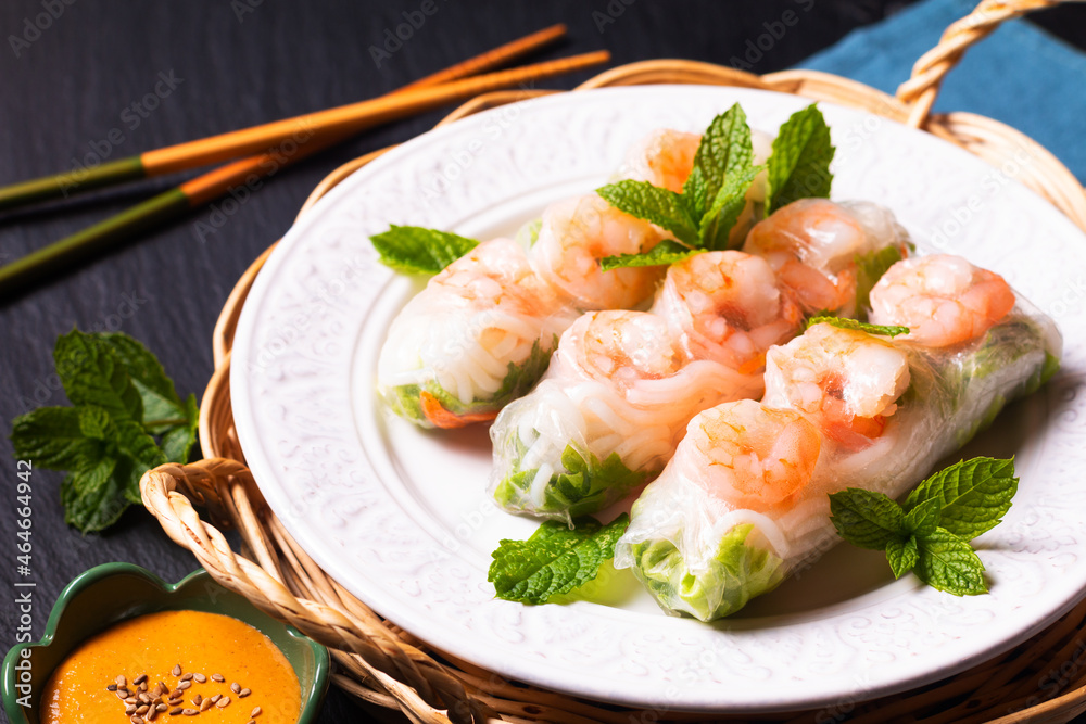 Food concept Asian food homemade prawn Vietnamese rice paper spring roll and peanut dipping sauce with copy space