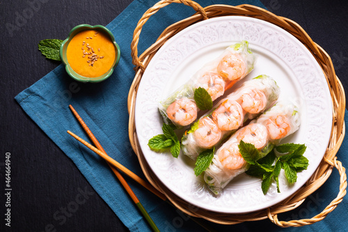 Food concept Asian food homemade prawn Vietnamese rice paper spring roll and peanut dipping sauce with copy space photo