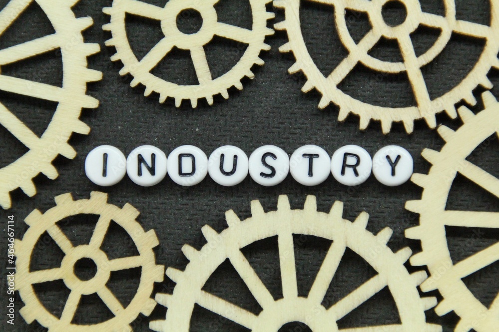 gear teeth and black letters in a white circle with the word industry