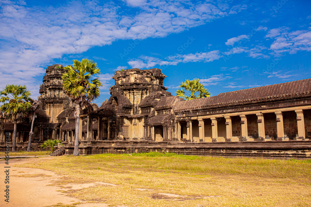 The ancient city of Angkor Wat in Cambodia. Towers of the temple of the Kmer people streets and ruins of houses. Traveling to the sights of ancient civilizations. Stone bas-reliefs on the ruins.