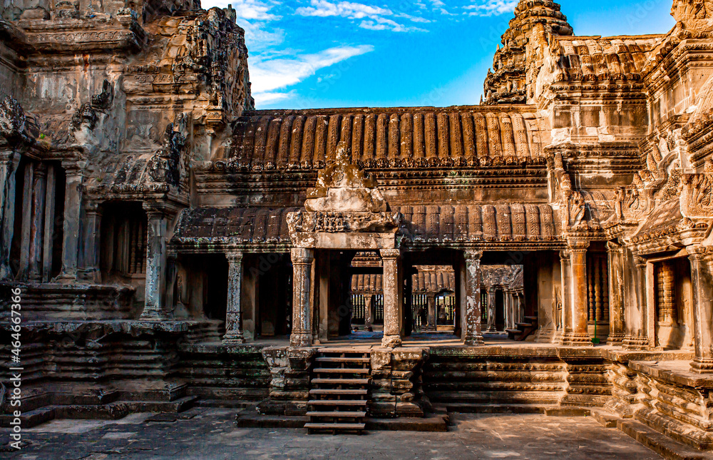 Obraz premium The ancient city of Angkor Wat in Cambodia. Towers of the temple of the Kmer people streets and ruins of houses. Traveling to the sights of ancient civilizations. Stone bas-reliefs on the ruins.