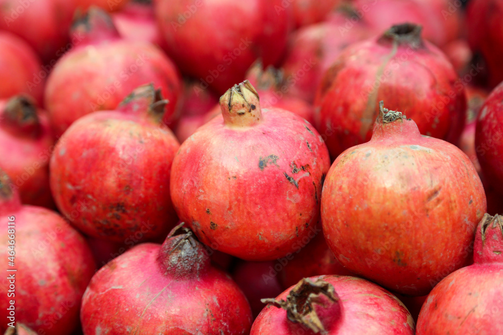 Pomegranate fruits in heap at market Pomegranate fruits in heap at market
