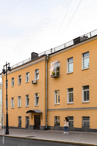 yellow house on Rozhdestvenka street in Moscow city in evening. Moscow courtyard of the Holy Dormition Pukhtitsky Monastery (Puhtitsa Convent)