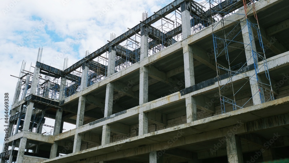 The building under construction overlooking the sky and clouds.