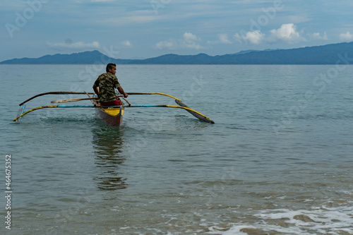 Traditional fisherman checking the net. Early morning Aninuan beach, Oriental Mindoro. Fishing culture of The Philippines. No fish, no money, no food