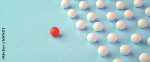 Leadership Concept: A group of white spheres with one sphere in red leading the group. Web banner format