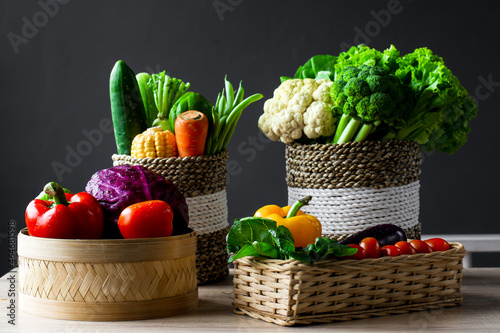 Fototapeta Naklejka Na Ścianę i Meble -  Various of fresh colorful vegetables in the wicker basket on wooden table
