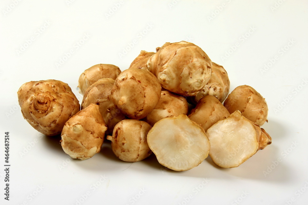 Jerusalem artichoke with white background, close up. Freshly harvested Jerusalem artichoke or topinambur 