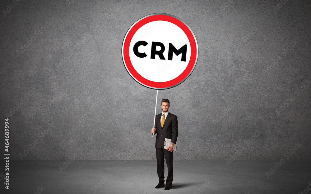 Fototapeta premium Young business person holdig traffic sign