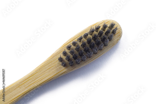 Wooden bamboo toothbrush with black bristles. Natural eco friendly zero waste item on white background