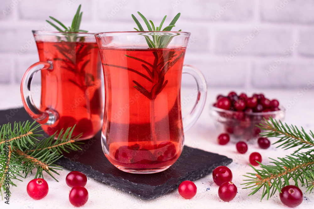 Cranberry cocktail with a sprig of rosemary. Close-up.