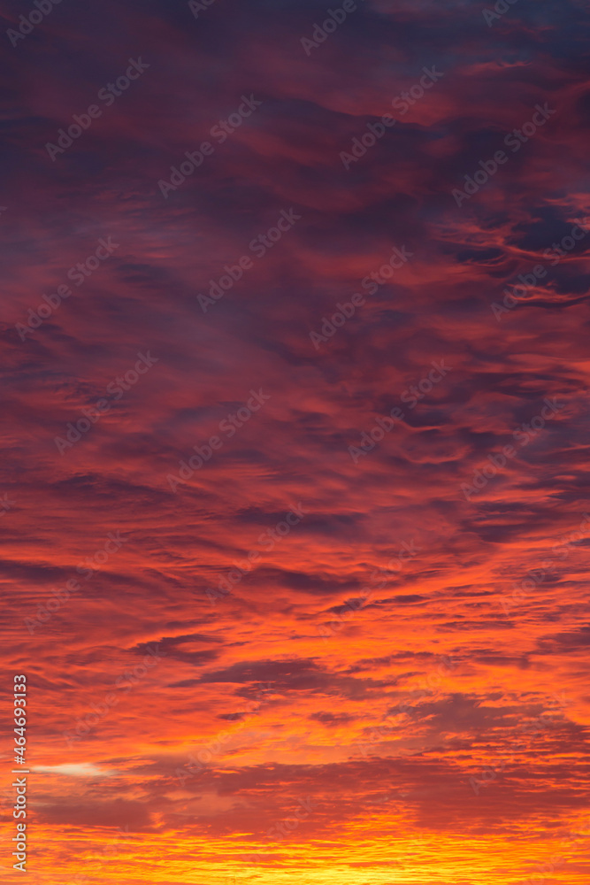 Epic Dramatic bright sunrise, sunset orange red pink sky with beautiful clouds in sunlight background texture