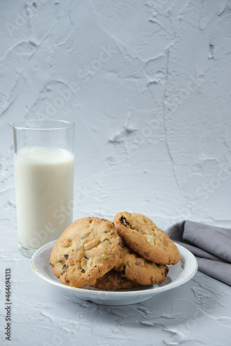 Glass of milk and cookies with white background