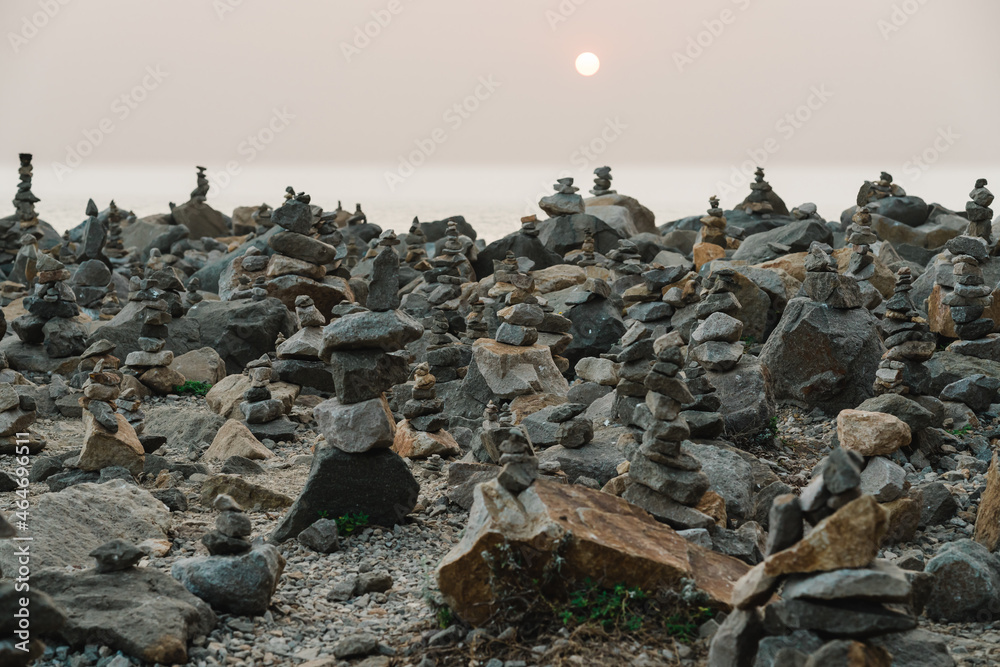Stacked pebbles on the beach at sunset. Zen, tranquility, harmony concept Stacked pebbles on the beach at sunset. Zen, tranquility, harmony concept
