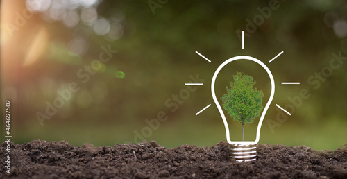 Green energy innovation light bulb with future industry of power generation icon graphic interface. Concept of sustainability development by alternative