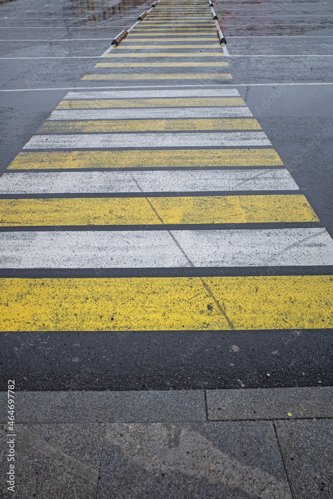 Pedestrian crossing at the parking lot in the early cold morning
