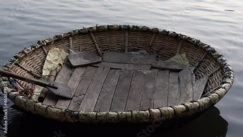 An empty Coracle parked in Cauvery river in Srirangapatna, Karnataka, India. A coracle is a small, bowl shaped, lightweight boat made of bamboo