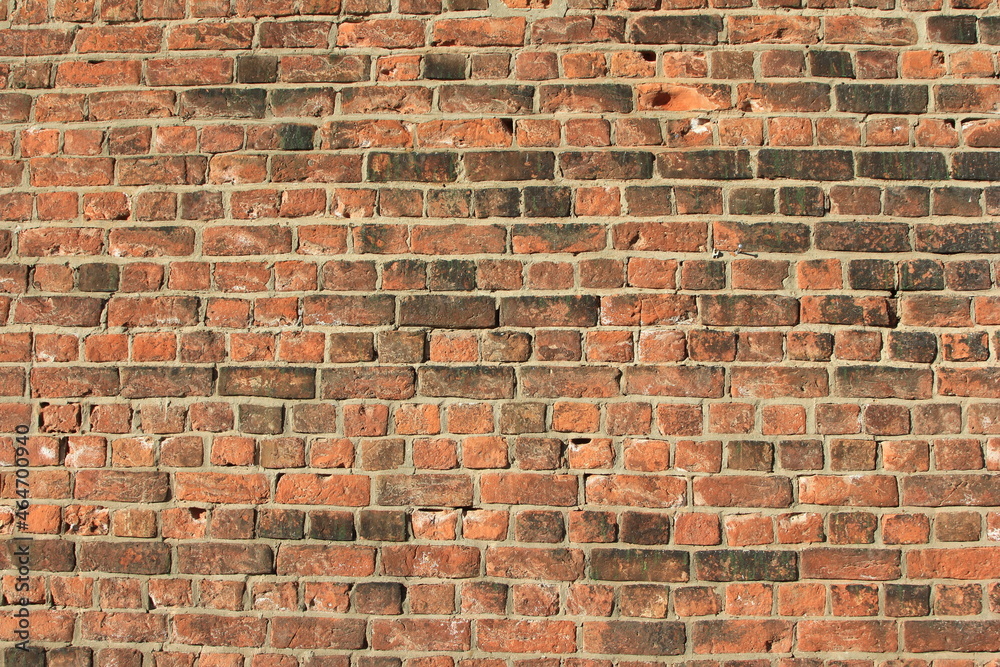 Obraz premium an old brick wall with bricks blackened by time