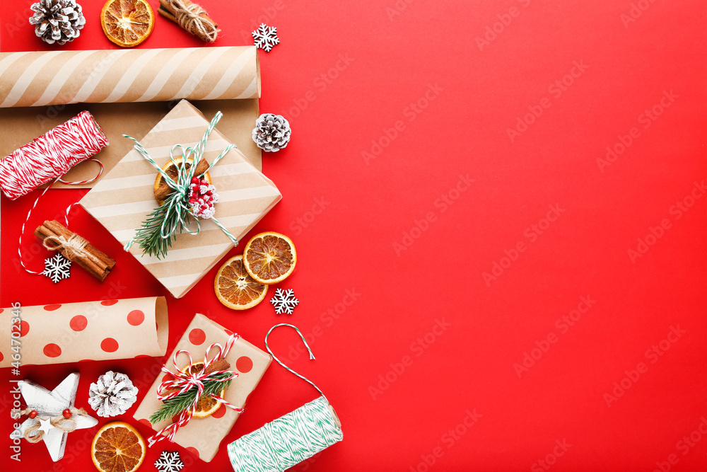 Gift boxes with ornaments on red background