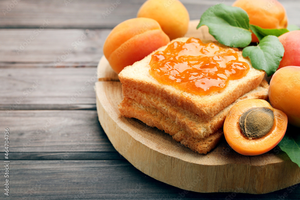 Apricots and toast with jam on brown background Apricots and toast with jam on brown background