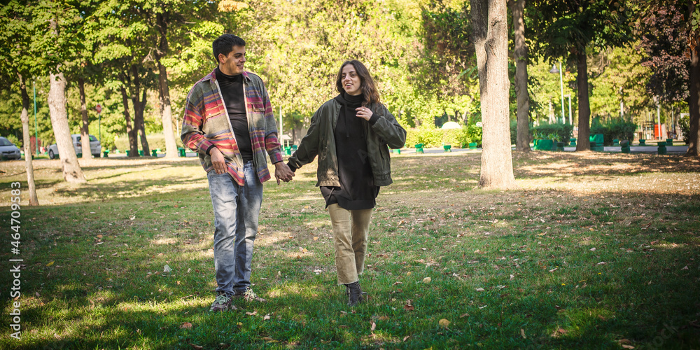 Fototapeta premium Cheerful and romantic couple in love, walk together in nature
