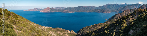 Panoramic view of the Gulf of Porto on the west coast of Corsica with mountains including Paglia Orba and Monte Senino in the distance