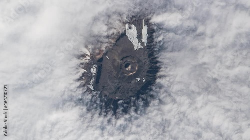 Mountain peak from clouds view from sky, aerial satellite scenic landscape of Kilimanjaro mount in Tanzania, Africa. Animation based on Nasa images photo