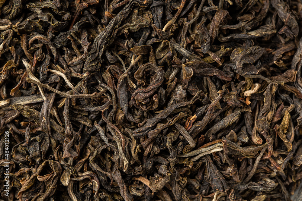 Heap of dry tea leaves. Dried black tea. Textured background of dried leaves of aromatic black tea with cinnamon Heap of dry tea leaves. Dried black tea. Textured background of dried leaves of aromatic black tea with cinnamon