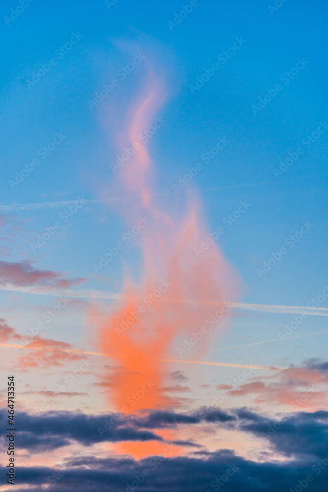 Orange cloud like flame in the evening blue sky