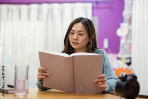 Woman read book to prepare for final exam