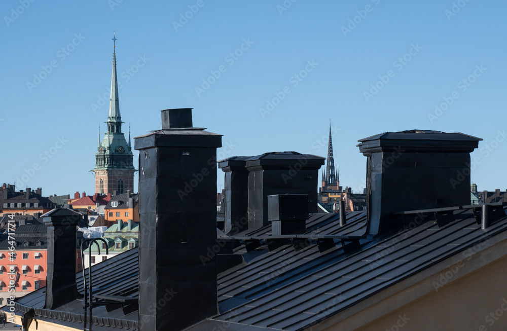 Roofs, chimneys and churches of the old town Gamla Stan a colorful autumn day in Stockholm