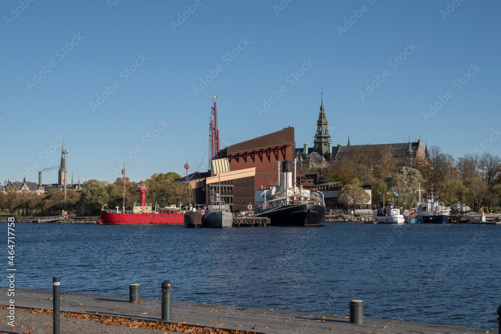 Fototapeta premium View over museums and landmarks on the island Djurgården from the island Skeppsholmen in Stockholm a color full autumn day