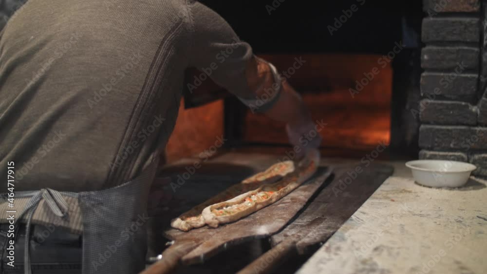 shot of cooking turkish bread cooked in wood fired oven. traditional recipe, food and drink close up footage. Turkish pide bread, tourism Turkey shot of cooking turkish bread cooked in wood fired oven. traditional recipe, food and drink close up footage. Turkish pide bread, tourism Turkey